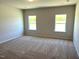 This bedroom features neutral carpeting, recessed lighting, and natural light from windows at 288 Olivia Crossing Ct # 10, Four Oaks, NC 27524