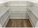Walk-in closet with custom shelving and hardwood floors, maximizing storage space at 288 Olivia Crossing Ct # 10, Four Oaks, NC 27524