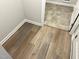 Hallway with wood-look flooring leading to tiled area at 288 Olivia Crossing Ct # 10, Four Oaks, NC 27524