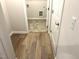Inviting hallway with hardwood flooring leading to laundry room at 288 Olivia Crossing Ct # 10, Four Oaks, NC 27524