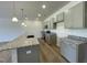 Bright kitchen features gray cabinets, a large island with a sink, and stainless steel appliances at 288 Olivia Crossing Ct # 10, Four Oaks, NC 27524