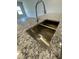 Close-up of kitchen island sink with stainless steel finish and white granite countertops at 288 Olivia Crossing Ct # 10, Four Oaks, NC 27524