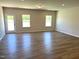 Bright living room features hardwood floors, recessed lighting, and plenty of natural light at 288 Olivia Crossing Ct # 10, Four Oaks, NC 27524