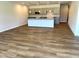 Open-concept living area showcasing the kitchen with island, and hardwood floors at 288 Olivia Crossing Ct # 10, Four Oaks, NC 27524