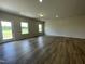 Open-concept living room features hardwood floors, recessed lighting, and backyard views at 288 Olivia Crossing Ct # 10, Four Oaks, NC 27524
