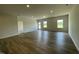 Spacious living room with hardwood floors and natural light from the large windows at 288 Olivia Crossing Ct # 10, Four Oaks, NC 27524