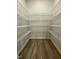 Walk-in closet with wood floor and white wire shelving offers ample storage at 288 Olivia Crossing Ct # 10, Four Oaks, NC 27524