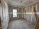 Bedroom features drywall, trimwork, and natural light from the window overlooking the neighborhood at 2895 Bakers Chapel Rd, Smithfield, NC 27577