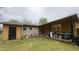 Spacious backyard featuring an exterior covered patio, grill and a black storage closet at 300 E Vance St, Zebulon, NC 27597