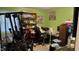 Cluttered green room with exercise equipment, shelves, and a desk at 300 E Vance St, Zebulon, NC 27597