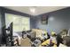 Bedroom featuring carpet flooring, a large window and a futon couch at 300 E Vance St, Zebulon, NC 27597
