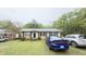Charming single-story home with a well-maintained front lawn and multiple cars parked in front at 300 E Vance St, Zebulon, NC 27597