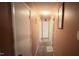 Long hallway with carpet flooring that leads to multiple rooms and closet doors at 300 E Vance St, Zebulon, NC 27597
