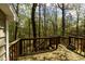 Wood back porch with steps down to yard and surrounded by trees offering privacy at 300 Nc 54 Highway # E2, Carrboro, NC 27510