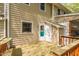This covered back porch has a wooden deck, siding, and access to the yard at 300 Nc 54 Highway # E2, Carrboro, NC 27510