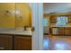 Bathroom with a view into the kitchen featuring bright yellow walls and hardwood floors at 300 Nc 54 Highway # E2, Carrboro, NC 27510