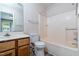 Cozy bathroom with a standard tub and shower combination and wood cabinets under the sink at 300 Nc 54 Highway # E2, Carrboro, NC 27510