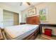 Sunlit bedroom features a large window, closet, and wood laminate floors at 300 Nc 54 Highway # E2, Carrboro, NC 27510