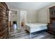 Neutral bedroom with gray wood floors, access to the bathroom, and a hall leading to other rooms at 300 Nc 54 Highway # E2, Carrboro, NC 27510