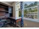 Cozy bedroom features a built-in desk area with a view of nearby townhomes through the window at 300 Nc 54 Highway # E2, Carrboro, NC 27510