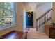 Welcoming foyer with hardwood floors, staircase, wreath, and a view of the exterior at 300 Nc 54 Highway # E2, Carrboro, NC 27510