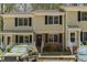 Charming townhome with covered porch, neutral siding, black shutters, and convenient parking at 300 Nc 54 Highway # E2, Carrboro, NC 27510