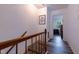Hallway with wood laminate floors and white walls leading to a bedroom with natural light at 300 Nc 54 Highway # E2, Carrboro, NC 27510