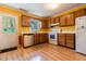 Sunny kitchen with wood cabinets, updated appliances, and a door leading to the outdoors at 300 Nc 54 Highway # E2, Carrboro, NC 27510