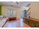 Inviting living room featuring hardwood floors, staircase, bright windows, and a blue front door at 300 Nc 54 Highway # E2, Carrboro, NC 27510