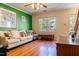 Bright living room with hardwood floors, a sofa, natural light, and a pop of color at 300 Nc 54 Highway # E2, Carrboro, NC 27510
