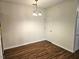 Dining area with hardwood floors, chandelier, and convenient access to other rooms at 3015 Winston Dr # 111, Burlington, NC 27215