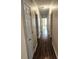 Hallway with hardwood floors, multiple doors, and overhead lighting at 3015 Winston Dr # 111, Burlington, NC 27215