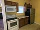 Functional kitchen featuring a range, microwave, refrigerator, and ample counter space at 3015 Winston Dr # 111, Burlington, NC 27215