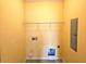 Laundry room with washer hookups, tile flooring, and yellow walls at 3015 Winston Dr # 111, Burlington, NC 27215