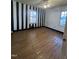 Unique bedroom featuring hardwood floors, modern ceiling fan and striking striped walls at 327 Holland Dr Rd, Smithfield, NC 27577