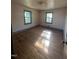 Cozy bedroom with hardwood floors and two large windows at 327 Holland Dr Rd, Smithfield, NC 27577
