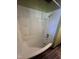 Enclosed tub-shower combination with tiled walls and built-in shelving at 327 Holland Dr Rd, Smithfield, NC 27577