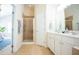 Bathroom with a tile shower, a large mirror, a white vanity, and neutral tile flooring at 3303 Silver Star Dr, Durham, NC 27713
