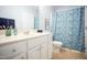 Bathroom featuring a white vanity, a blue floral shower curtain, and neutral tile flooring at 3303 Silver Star Dr, Durham, NC 27713