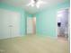 Bright bedroom featuring light green walls, neutral carpet, and an open doorway to the bath at 3303 Silver Star Dr, Durham, NC 27713