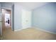 Empty bedroom with neutral carpet and light blue walls with a double-door closet at 3303 Silver Star Dr, Durham, NC 27713