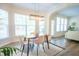 Bright dining area with views into the living room, highlighted by a modern light fixture and stylish decor at 3303 Silver Star Dr, Durham, NC 27713