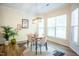 Bright dining area with modern lighting, stylish decor, and a view of the natural light from large windows at 3303 Silver Star Dr, Durham, NC 27713