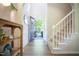 Bright foyer with a staircase and open doorway leading to a sunny exterior, enhancing the welcoming ambiance at 3303 Silver Star Dr, Durham, NC 27713