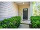 Charming entryway with a black front door, lovely greenery, and neutral siding for a welcoming appeal at 3303 Silver Star Dr, Durham, NC 27713
