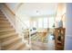 Bright living room features a cozy seating area, abundant natural light, and a charming staircase at 3303 Silver Star Dr, Durham, NC 27713