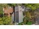 An aerial view of a home with a chimney and landscaping, nestled among mature trees at 3308 Churchill Rd, Raleigh, NC 27607