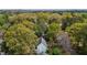 Overhead shot of a house and neighborhood with mature trees and well-maintained homes, nestled among beautiful landscaping at 3308 Churchill Rd, Raleigh, NC 27607