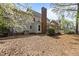 The spacious backyard features mature trees and a covered porch for outdoor enjoyment at 3308 Churchill Rd, Raleigh, NC 27607
