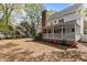 Large backyard with a covered porch, chimney, garden, and a spacious area for outdoor activities and relaxation at 3308 Churchill Rd, Raleigh, NC 27607